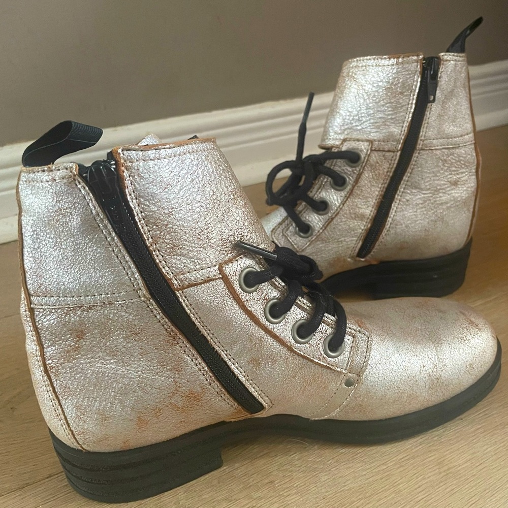FLY LONDON distressed metallic combat boots.